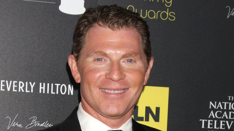 Bobby Flay smiles on the red carpet