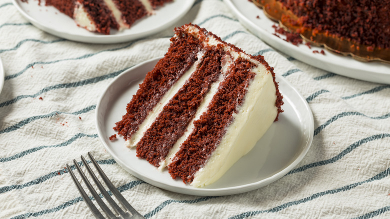 slice of dark red velvet cake on a plate