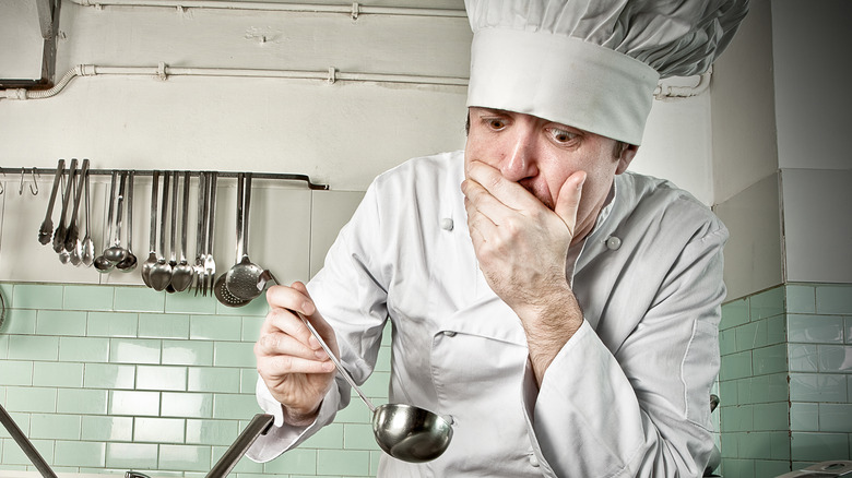 Chef looking down in kitchen