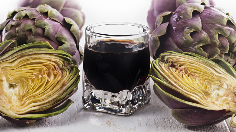 Cynar surrounded by artichokes