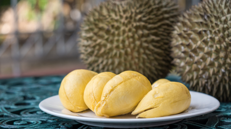 Fresh durian sections on a white plate