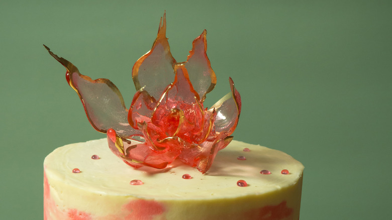 Edible, red isomalt flower on top of a cake