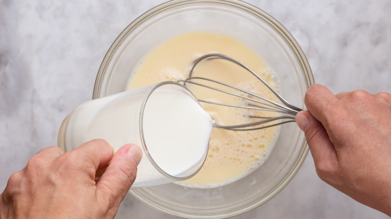 pouring milk into pancake mix