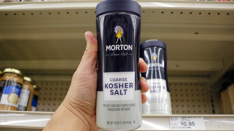 A shopper holding Morton kosher salt