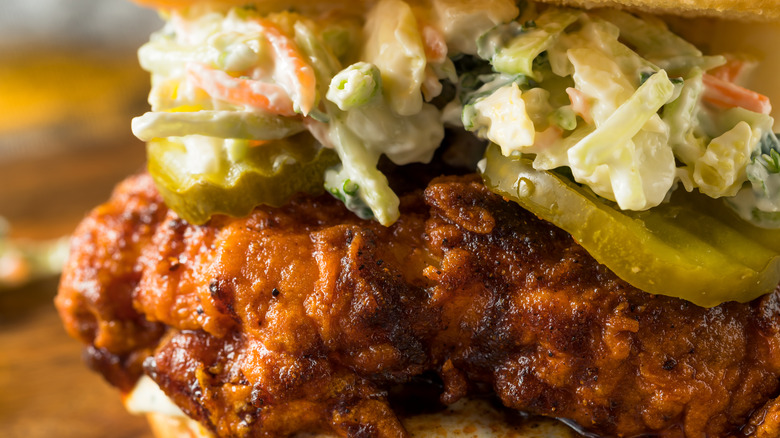 closeup shot of a Nashville hot chicken sandwich with pickles and coleslaw