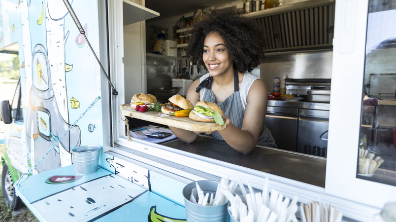 Woman working a burger stand