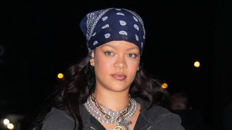 Rhianna wearing a blue and white bandanna pictured while out at night