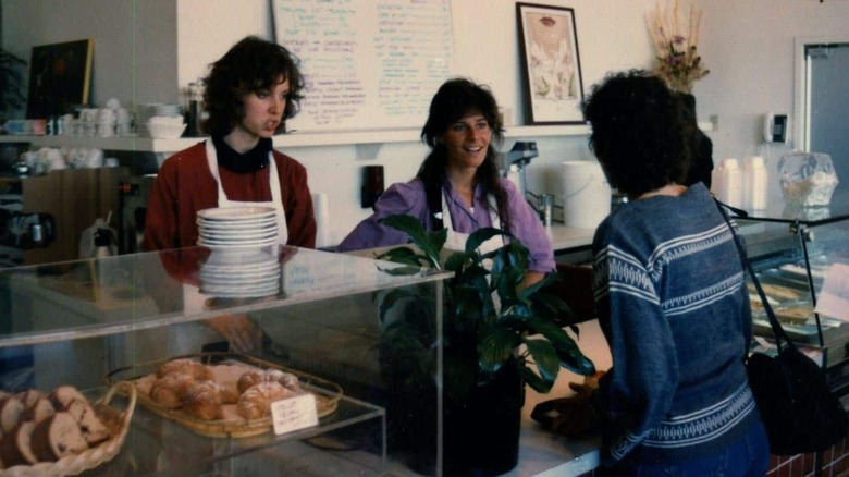 Co-founder Renee Lawson Hardy and a colleague speaking to a customer at the baked goods section