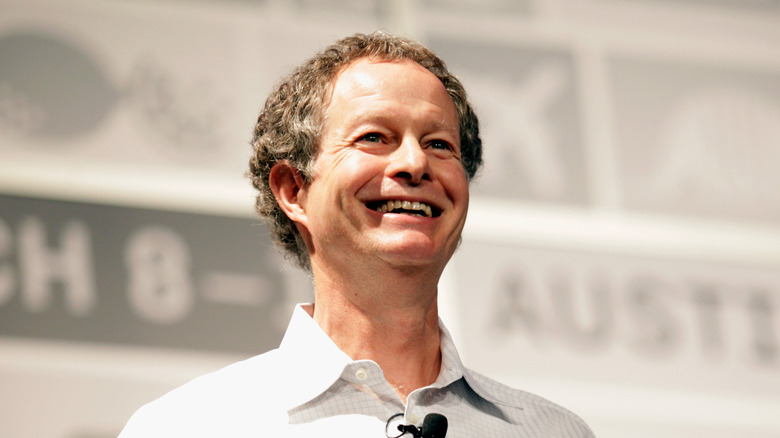 Former Whole Foods Market CEO John Mackey in a white shirt and smiling