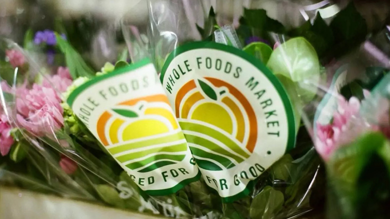 Two plants wrapped in 'Sourced for Good' packaging at a Whole Foods Market store