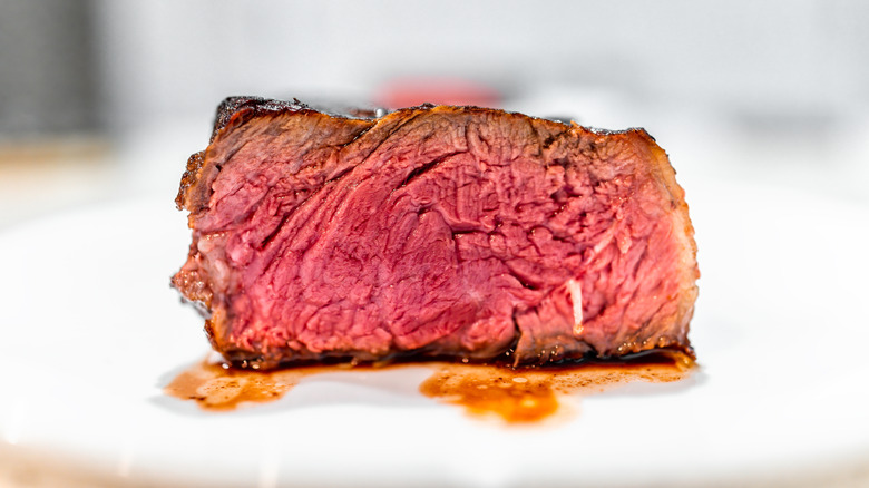 A cross section of a blue rare steak with a deep red interior