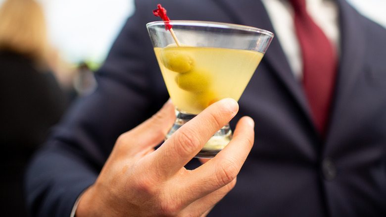 Man holding dirty martini