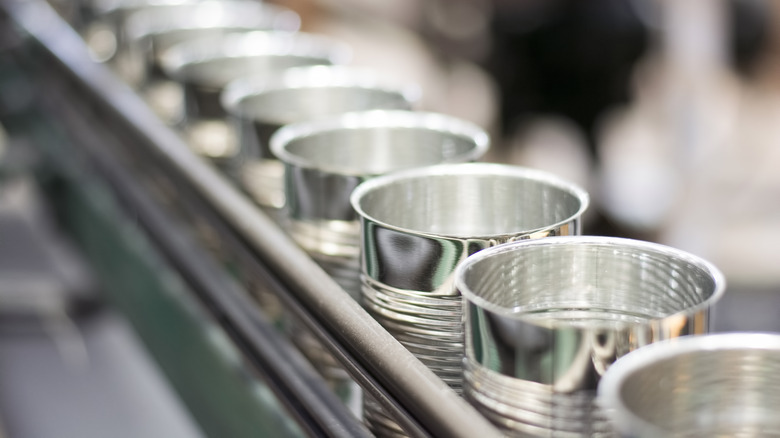 empty cans on conveyor belt