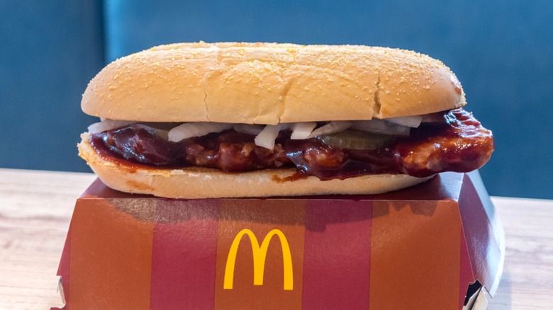 A McDonald's McRib sandwich on box with McDonald's logo