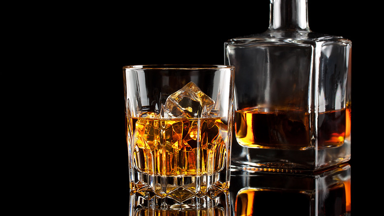 Whiskey glass and decanter black background