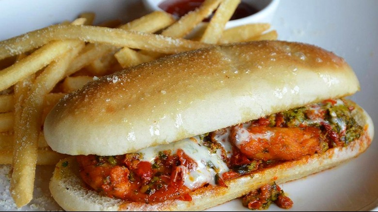 Olive Garden's Spicy Calabrian Chicken Breadstick sandwich beside fries and ketchup