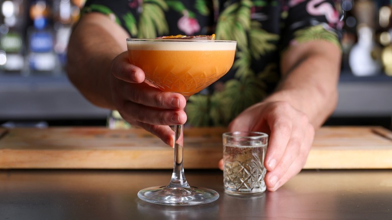 Bartender serving a pornstar martini