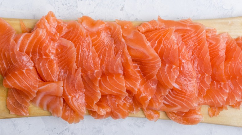 Overview of smoked salmon on a wooden cutting board