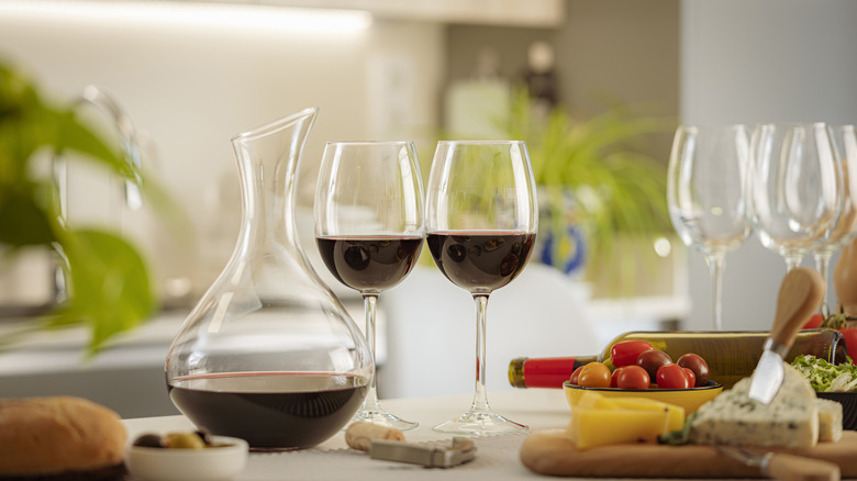 Wine decanter and two wine glasses with red wine