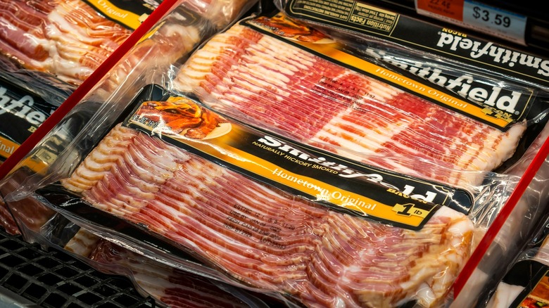 Packages of Smithfield bacon on store shelf