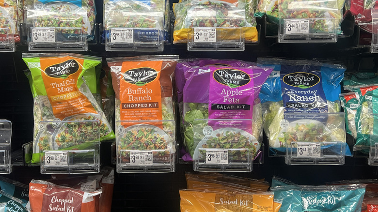 Bagged salads on Trader Joe's cold shelves