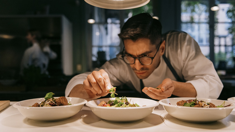 Chef puts finishing touches on a dish