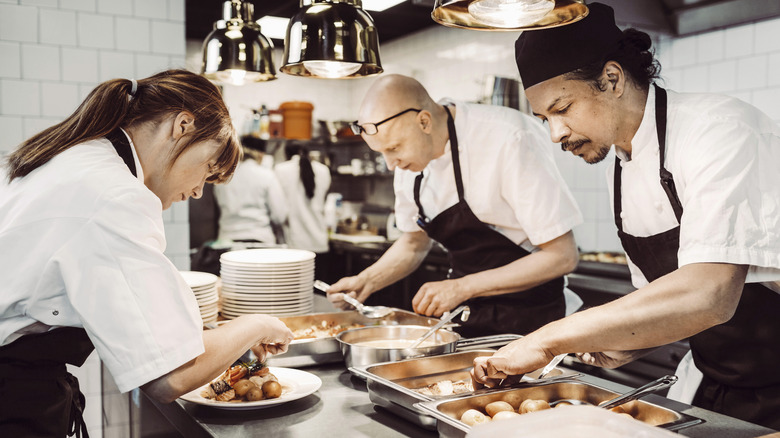 Chefs prep and plate food