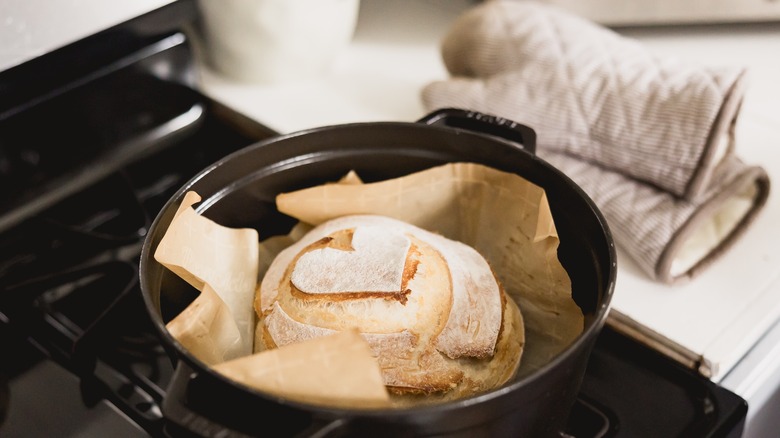 Dutch oven with bread and oven mitts