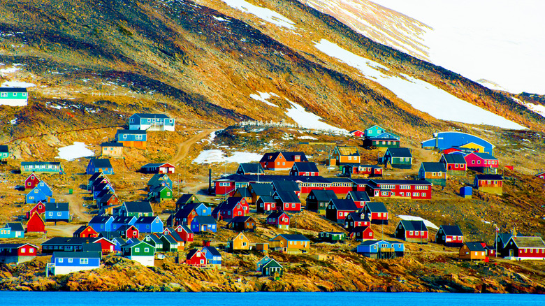 Ittoqqortoormiit village in Greenland, seen from sea.