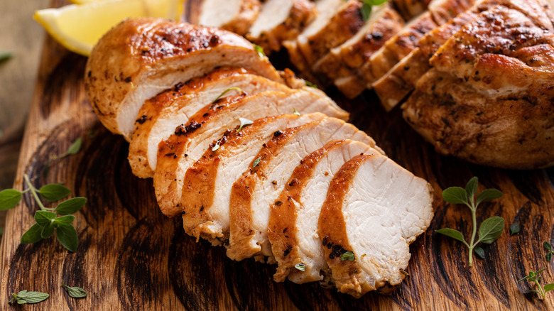 Roasted chicken breast sliced on a serving plate.