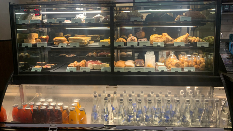 Starbucks display case with pastries and bottled drinks.