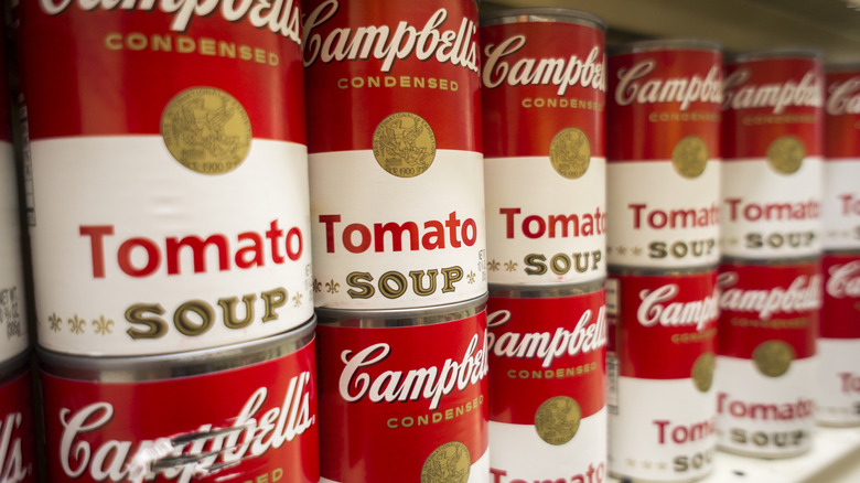 cans of Campbell's condensed tomato soup on a grocery store shelf