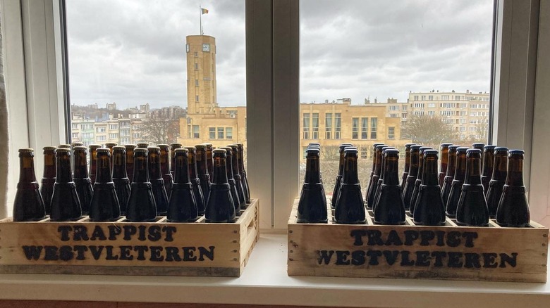 Crates of Westvleteren 12 beer with Belgian flag in the background