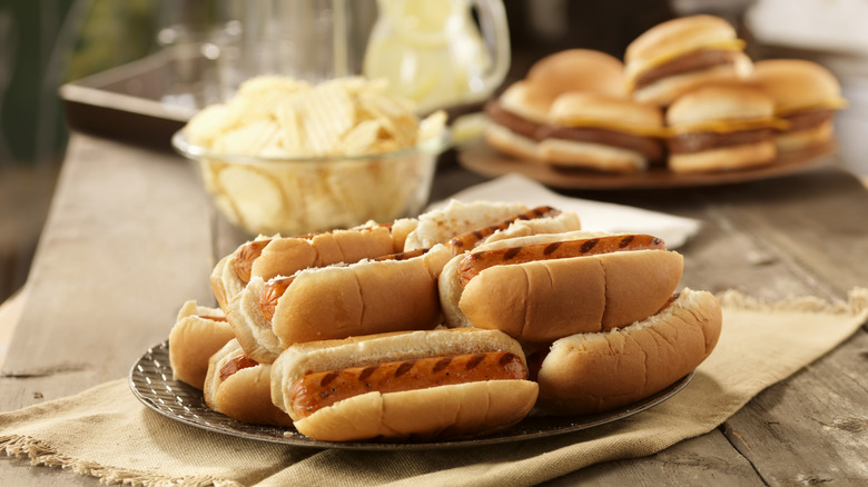 Plate of grilled hot dogs in buns