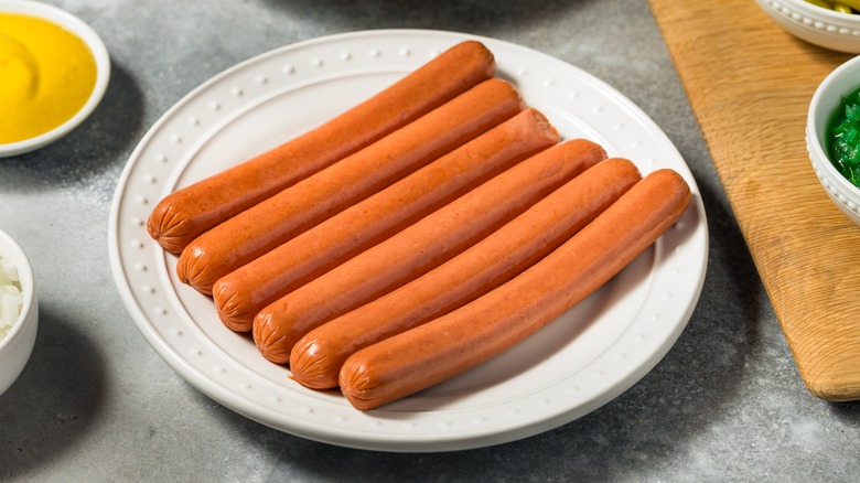 Plate of uncooked hot dogs