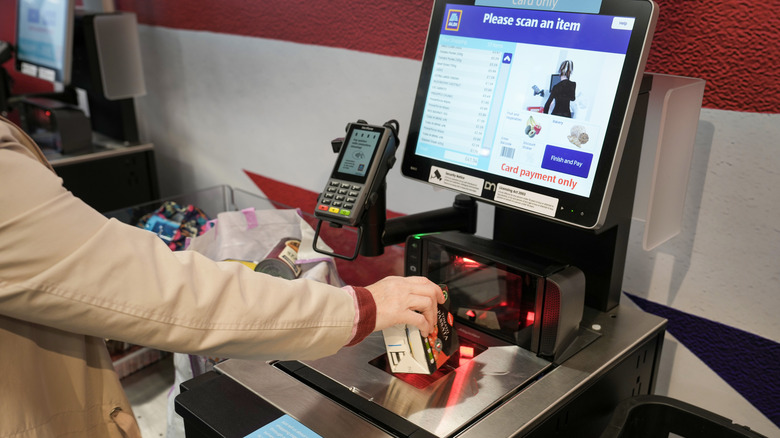 Aldi shopper scanning items at self-checkout