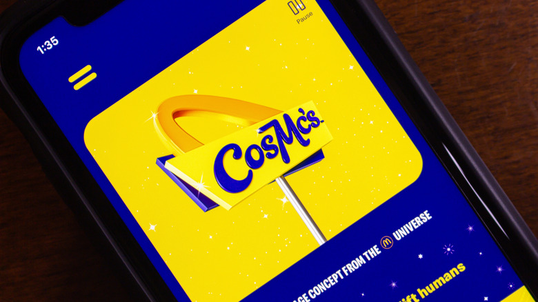 A phone screen reveals the CosMc's logo on its app