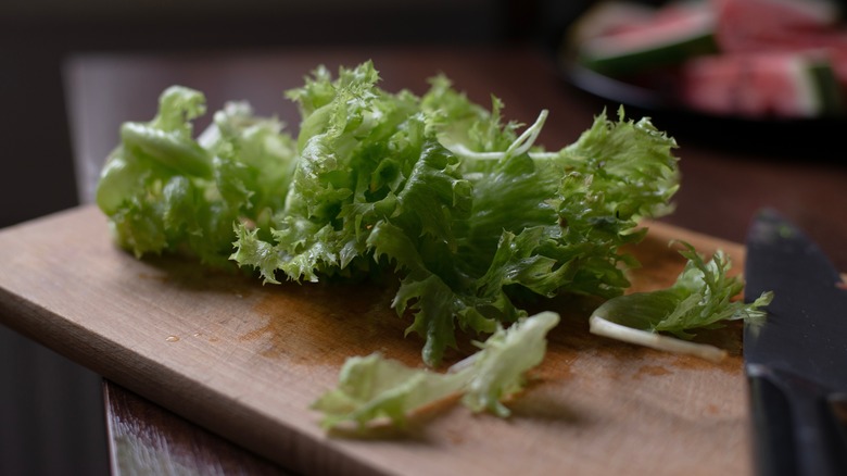 Crisp fresh lettuce leaves on a chopping board