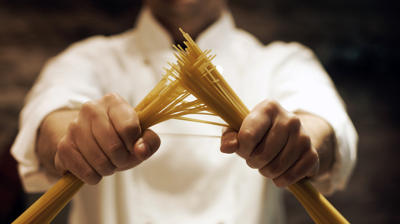 Chef holding raw spaghetti