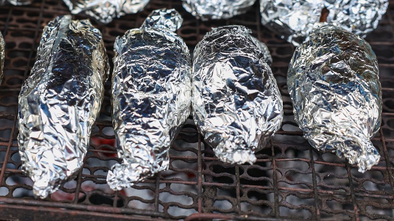 Potatoes wrapped in foil on grill