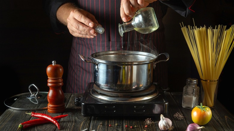 pouring oil into water