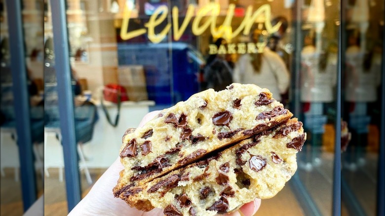 Cookie being held in front of Levain bakery