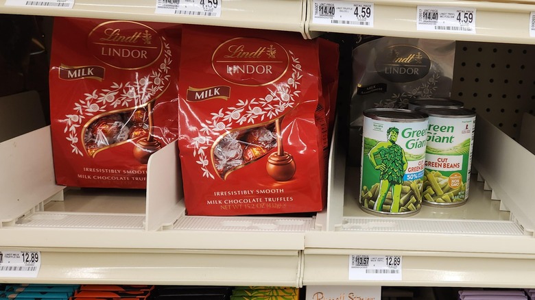 Cans of green beans next to lindor chocolates