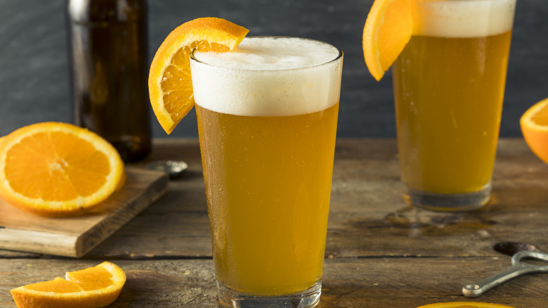 Beers garnished with orange wedges