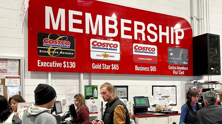 Costco membership counter with employees and customers.