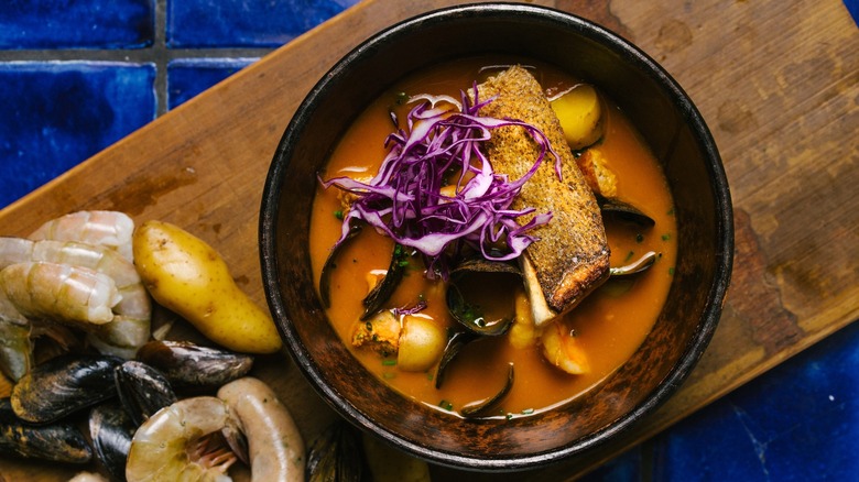 Sopa de Mariscos served at Holbox, on wood board next to shrimp and mussels