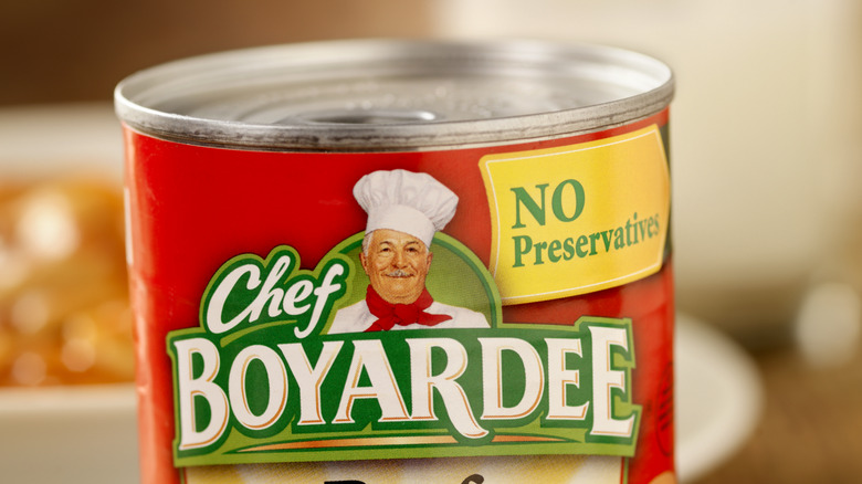 Person holding box of Chef Boyardee pizza maker