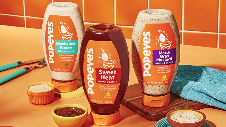 An image of three varieties of Popeyes bottled sauces