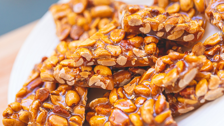 Pile of peanut brittle pieces, closeup.