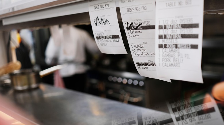 order receipts hanging in restaurant kitchen